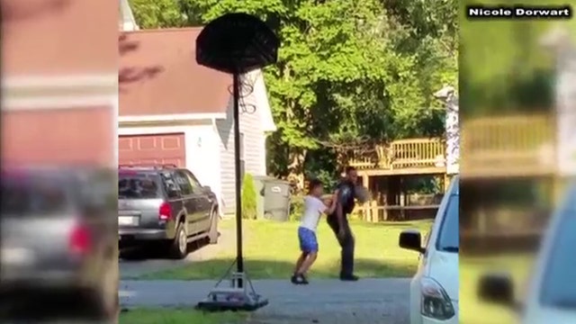 Calvert County sheriff's deputy plays basketball with young boy