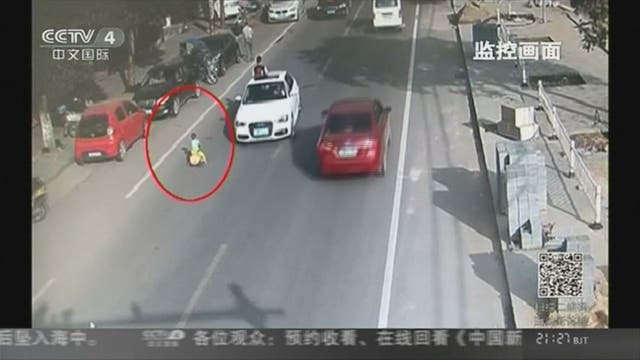 WATCH: Boy rides toy car through traffic
