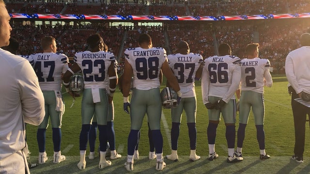Cowboys stand during anthem; other players continue to protest