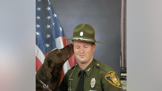 K-9 can't resist smooching officer in professional photo shoot