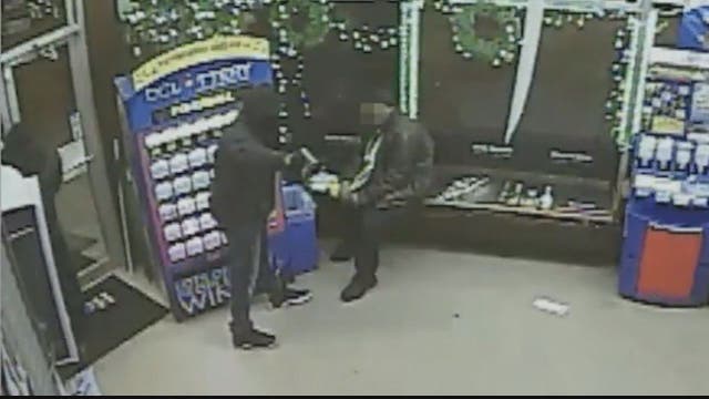 VIDEO: Man checking lottery tickets unmoved by armed robbery taking place