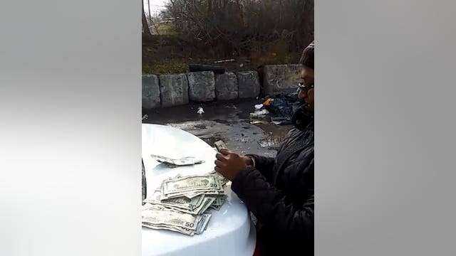 Sanitation workers dig through garbage, find woman's cash