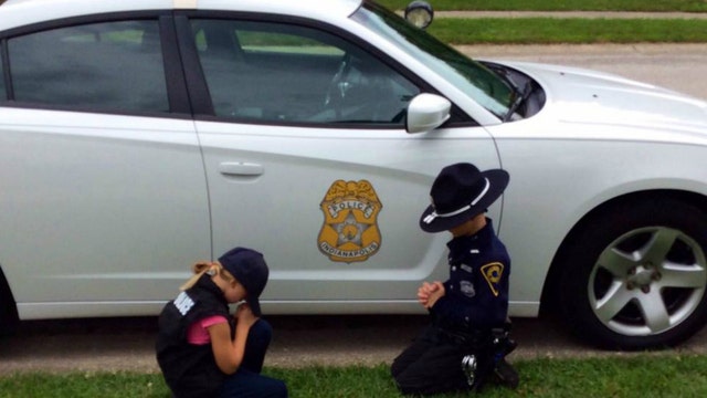 Officer's son and daughter pray for his safe return