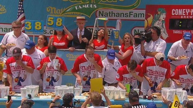 Defending champ Chestnut sets record with 74 hot dogs