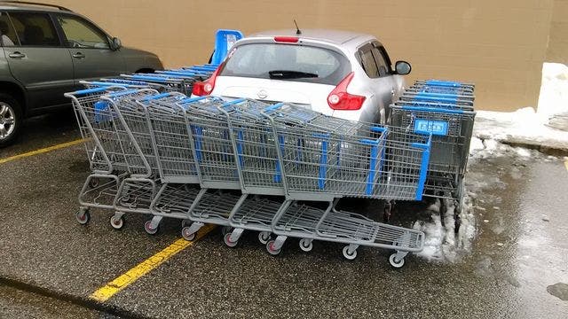 Double-parked car blocked with shopping carts