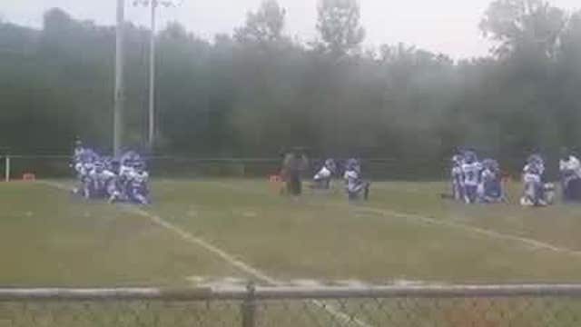 Youth football players kneel during National Anthem