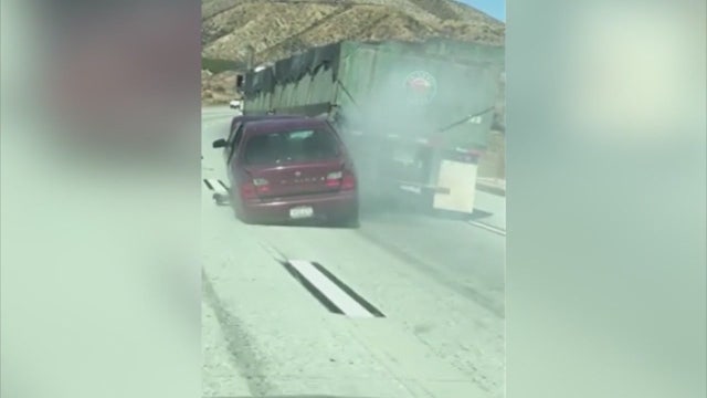 VIDEO: Big rig collides, drags car for miles on the I-15 freeway