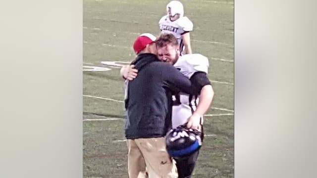 Powerful Photo Captures Father and Son Hugging After Overcoming Hardships