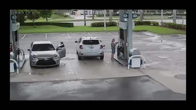Crouching suspect steals from woman at gas pump