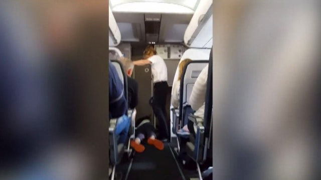 Video: Plane passenger has meltdown, strips in aisle