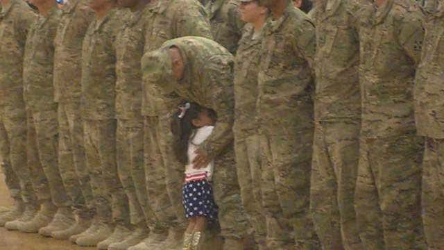 Soldier breaks formation to hug daughter