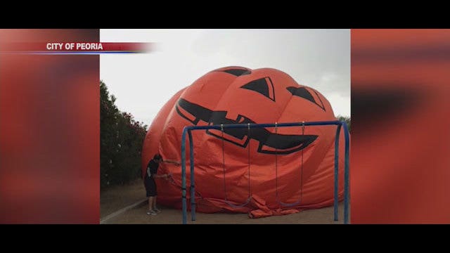 Giant inflatable pumpkin rolls through the streets of Peoria