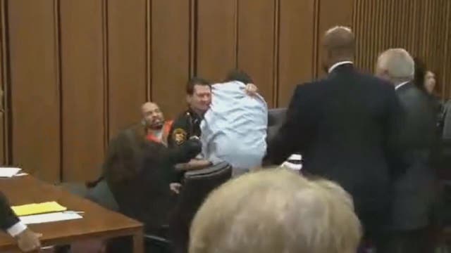 Victim's dad jumps over table to attack her killer in court