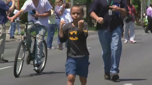 Boy 'shadowboxes' next to hearse carrying Muhammad Ali