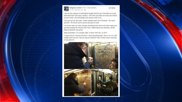 New York Subway riders use hand sanitizer to remove Swastikas from advertisements
