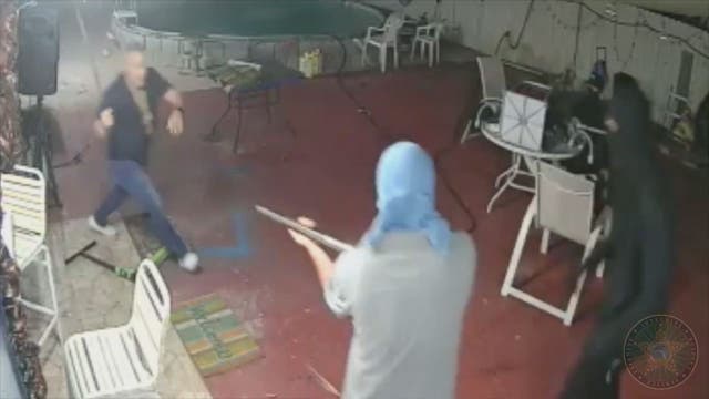 Watch: Man grabs machete, chases off armed robbers