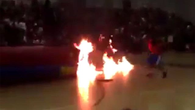 Performer catches fire during school pep rally