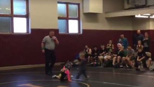 Toddler interrupts wrestling match to 'save' older sister