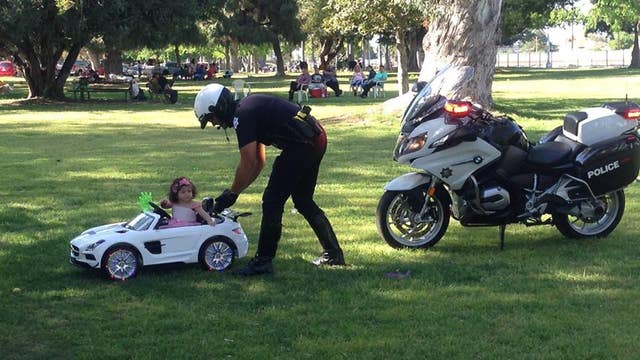 Officer pulls over little princess driving toy sports car in park, wishes her a Happy Easter