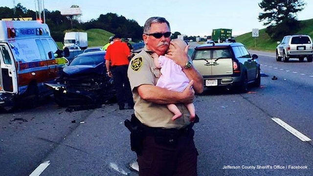 PHOTO: Deputy comforts baby after crash