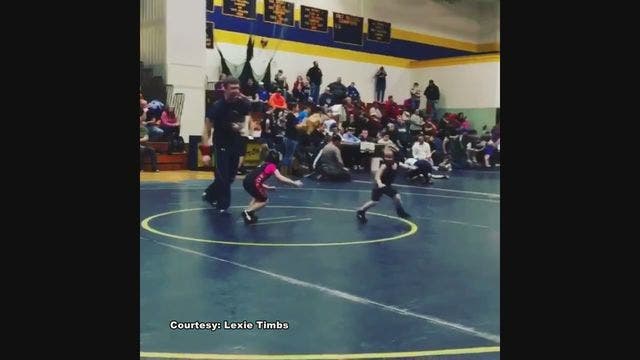 Boy runs in circles to avoid wrestling girl