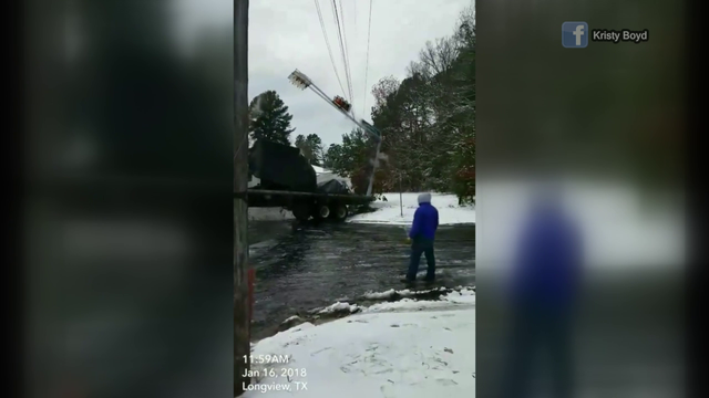 Icy Texas road causes 18-wheeler to crash into traffic light