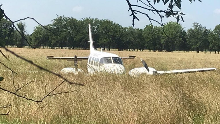 ba13cc59-McKinney plane in field