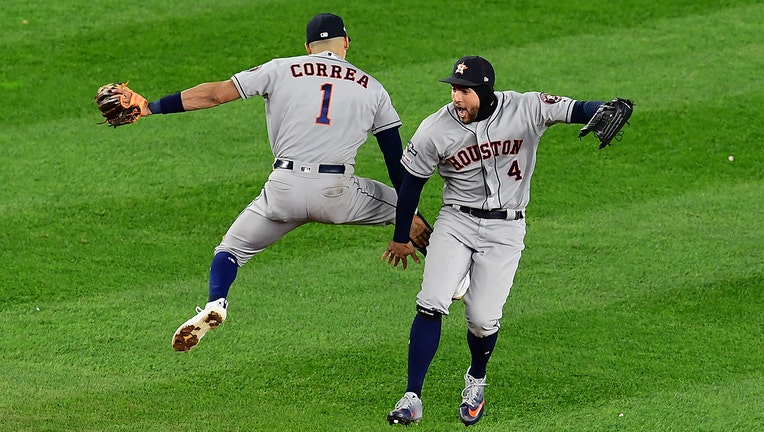 NEW YORK, NEW YORK - OCTOBER 17: Carlos Correa #1 and George Springer #4 of the Houston Astros celebrate an 8-3 win of game four of the American League Championship Series against the New York Yankees at Yankee Stadium on October 17, 2019 in the Bronx borough of New York City. (Photo by Emilee Chinn/Getty Images)