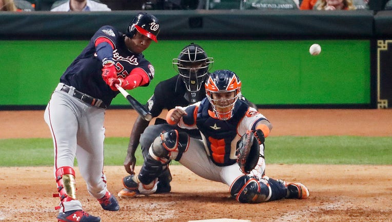 HOUSTON, TEXAS - OCTOBER 22: Juan Soto #22 of the Washington Nationals hits a two-RBI double against the Houston Astros during the fifth inning in Game One of the 2019 World Series at Minute Maid Park on October 22, 2019 in Houston, Texas. (Photo by Tim Warner/Getty Images)