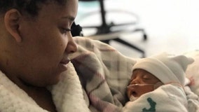 CVS employee holds baby boy for first time since shooting