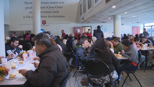 Volunteers serve Thanksgiving meals to veterans, first responders and the homeless