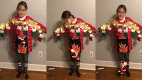 Santa slides down the chimney in mom’s epic ugly Christmas sweater for daughter