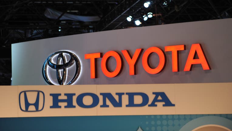 d9570ff8-The logos for Toyota and Honda are seen at the New York International Auto Show in New York.