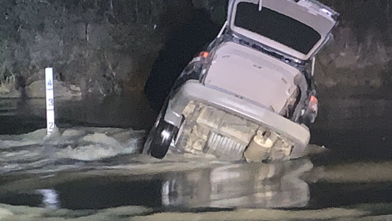 Driver rescued after vehicle is swept away in high water