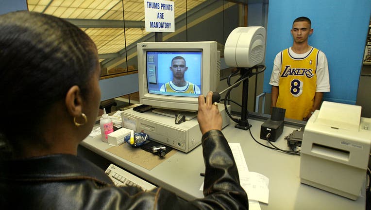 Los Angeles, At the State of California Department of Motor Vehicles Office on South Hope Street in LA; Marlon Aguilar is having his photo taken before he takes the test for a driver's license. He is at the counter where DMV photos are taken. Behind the Wheel column on a man who has had a valid, photoless driver's license for 20 years, thanks to a court order barring the DMV from taking his photo on the grounds that it violated the man s freedom of religion. The DMV is now going to court to dissolve the court order, in an effort to require that everyone have photos on their driver's license. (Photo by Al Seib/Los Angeles Times via Getty Images)