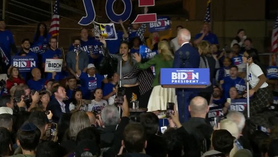 Women holding 'let dairy die' signs storm stage at Biden Super Tuesday event