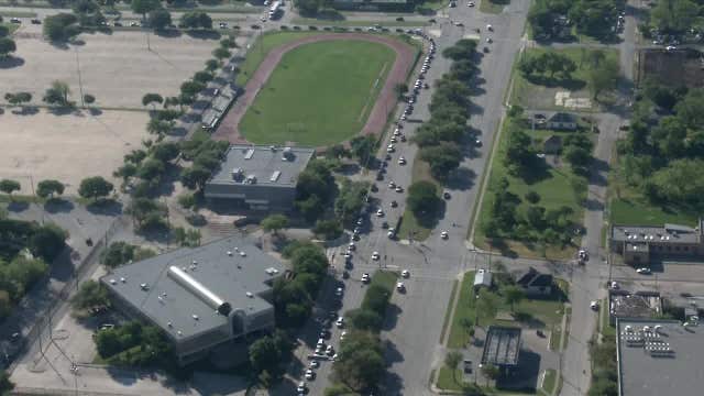 Line of cars wrapped around Fair Park for food pantry distribution
