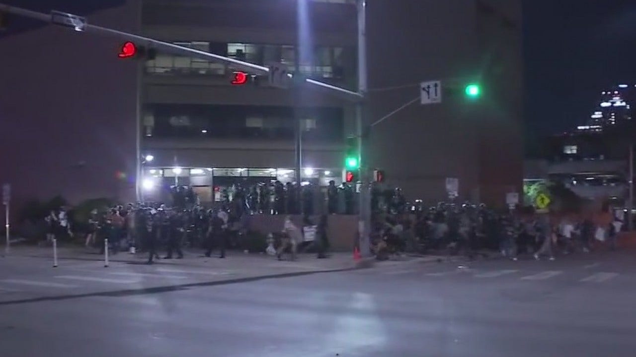 Driver in pickup truck goes around barricades into crowd of downtown ...