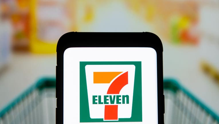 In this photo illustration a 7 Eleven logo seen displayed on