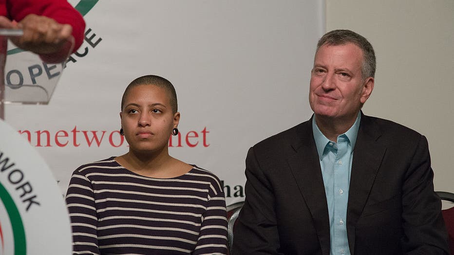 Chiara (left) and her father, Bill de Blasio (right), listen