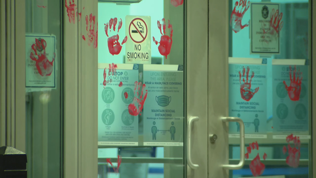 Dallas police headquarters vandalized with red handprints