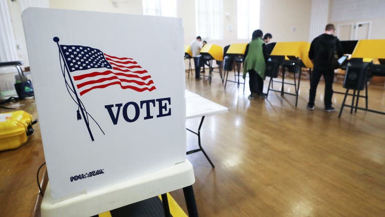 FILE - Voters prepare their ballots in voting booths during early voting for the California presidential primary election at an L.A. County vote center on March 1, 2020 in Los Angeles, California.