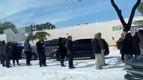 Austin residents line up for supplies in bitter cold, snow outside area grocery stores