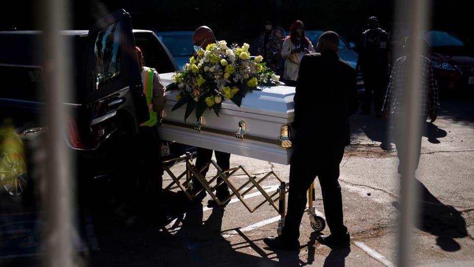 FILE - A casket is loaded into a hearse at the Boyd Funeral Home on Jan. 14, 2021 in Los Angeles, California.