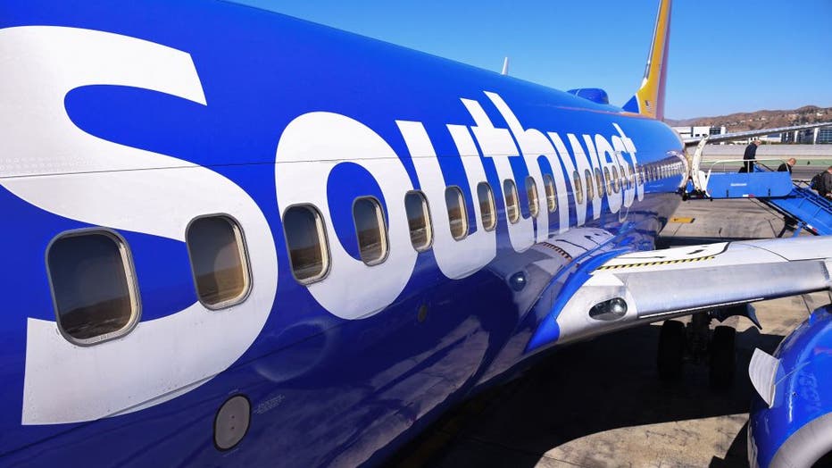 Passengers deplane from a Southwest Airlines flight from Las Vegas at Hollywood Burbank Airport in Burbank, California, Oct. 10, 2021. (Photo by ROBYN BECK/AFP via Getty Images)