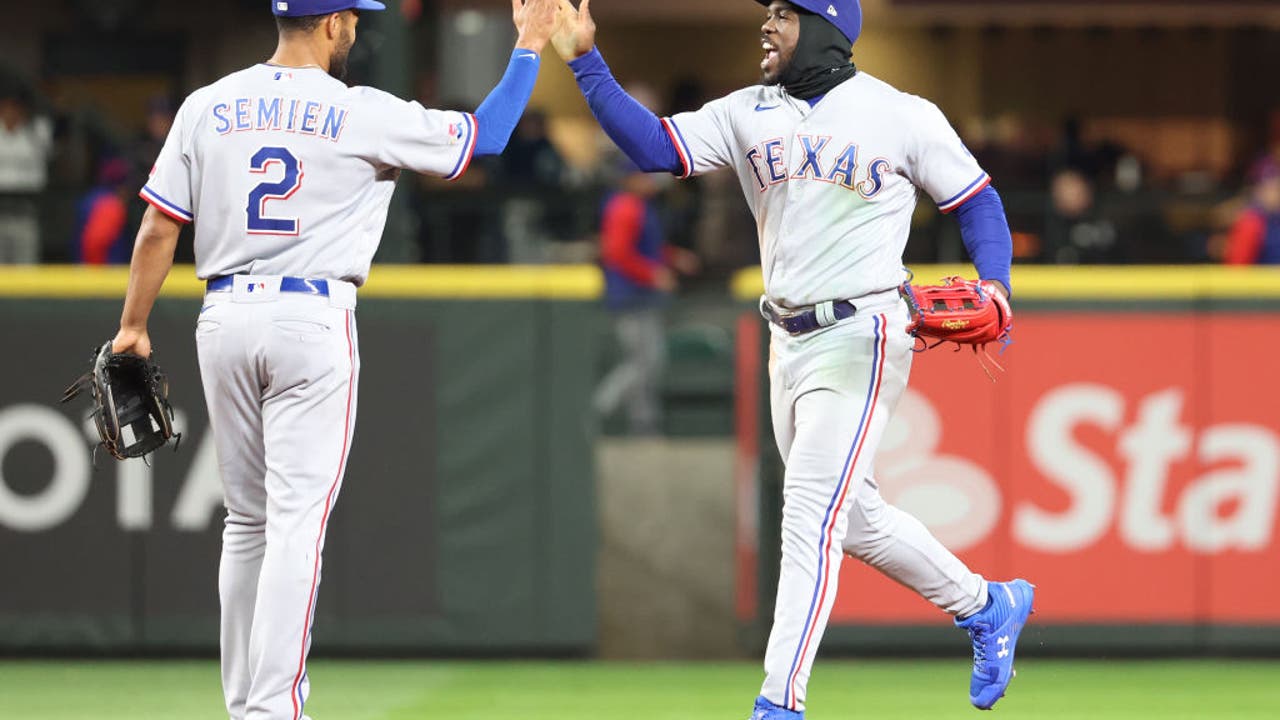 Texas Rangers left fielder Kole Calhoun makes a diving catch on a