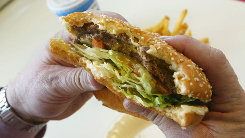 A-customer-takes-a-bite-out-of-a-hamburger.jpg