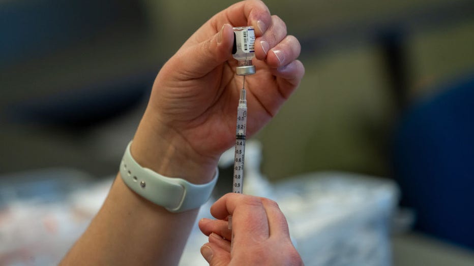 FILE IMAGE - A healthcare worker prepares a dose of the Pfizer-BioNTech Covid-19 vaccine at a vaccination clinic in the Peabody Institute Library in Peabody, Massachusetts, U.S., on Jan. 26, 2022. Photographer: Vanessa Leroy/Bloomberg via Getty Images
