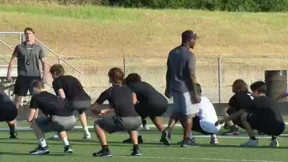 High school athletes endure workouts in the Texas heat