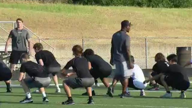 High school athletes endure workouts in the Texas heat